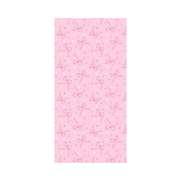 Pink tissue paper with bow and floral dot and star pattern on a white background